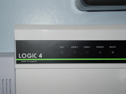 [Photo: Logic 4 alarm control box]