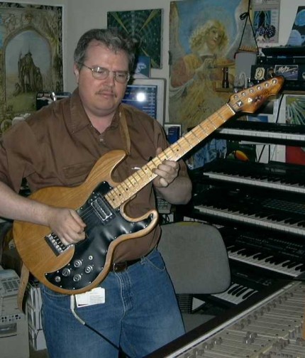 Tim in his studio playing his guitar